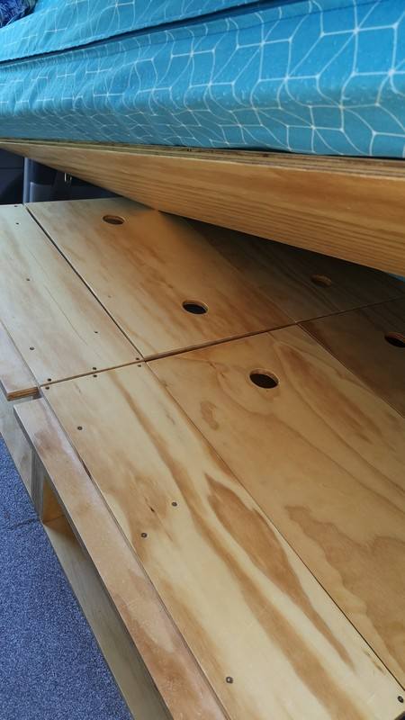 Plywood bed base panels of the FYC899 campervan with the mattress resting on top
