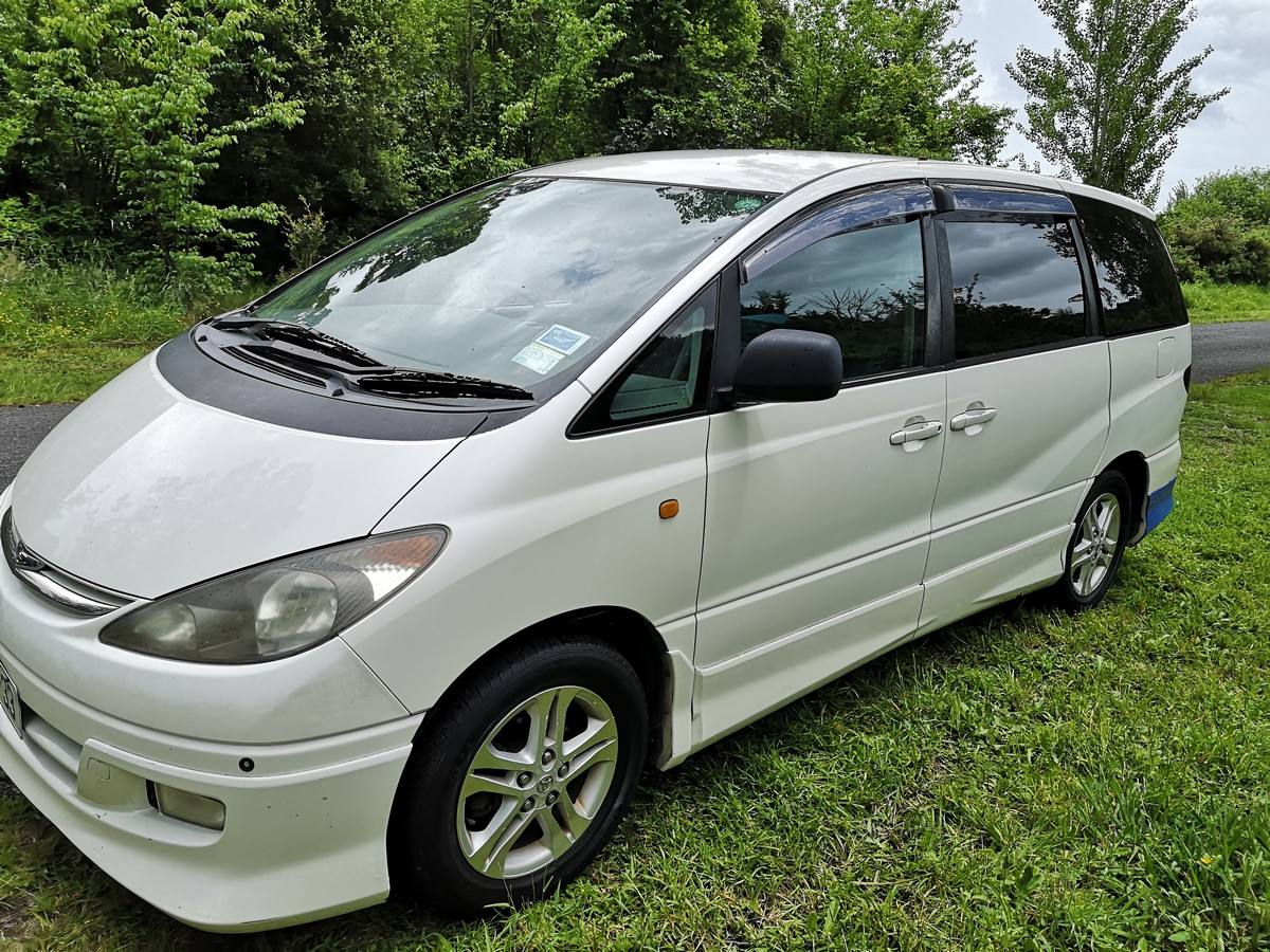 White 2001 Toyota Estima self-contained campervan for sale, front three-quarter view from the driver's side