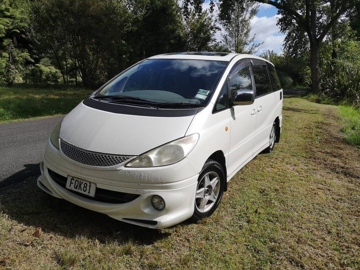 Front three-quarter view of the FQK81 Toyota Estima campervan on a country road