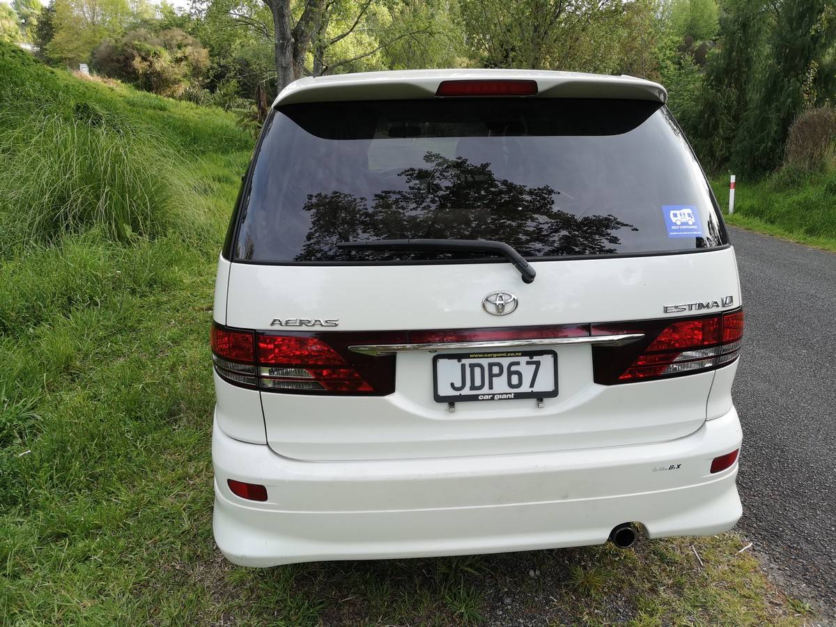 Back of the JDP67 Toyota Estima campervan, registration plate and green self-contained sticker