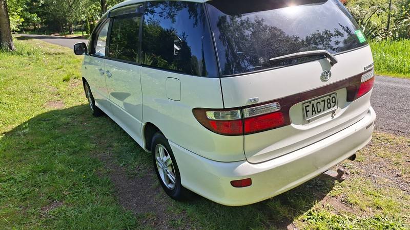 Rear three-quarter view of the white Toyota Estima campervan with registration FAC789