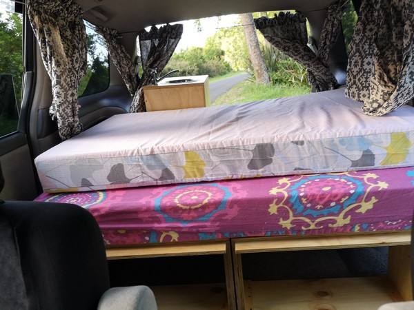 The FPS382 campervan's bed made up, looking forward towards the cab