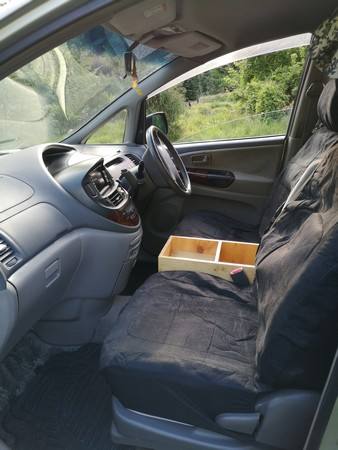 Driver's side of the FPS382 Toyota Estima cab, seat covers and console box between the seats