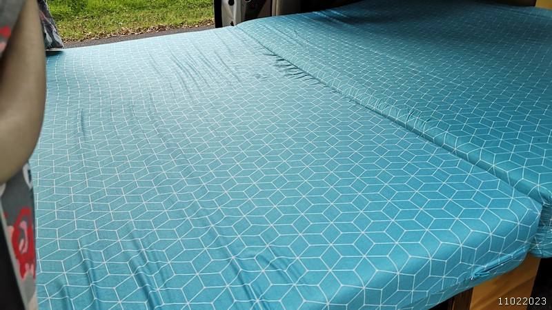 Close view of the made-up double bed in the JBB773 Toyota Estima campervan