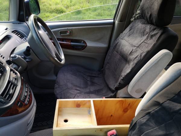 Steering wheel, front seats and plywood console box of the FPS382 Toyota Estima campervan