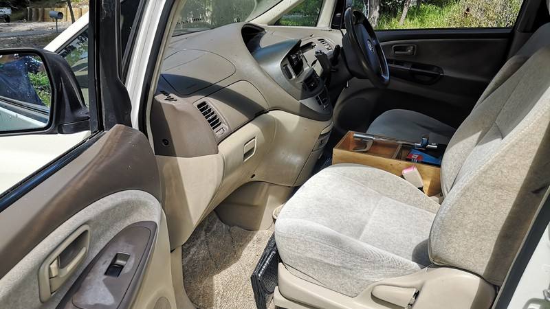 Dashboard and front seats of the GQG541 Toyota Estima, plywood console box between the seats