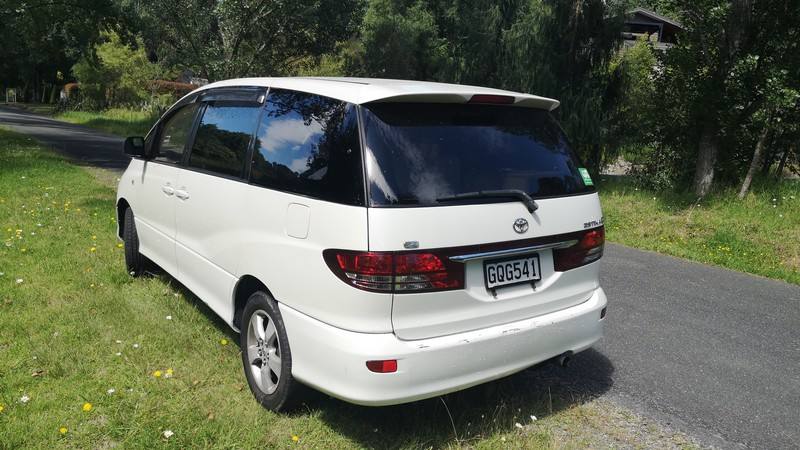 Rear three-quarter view of the GQG541 Toyota Estima campervan with the self-contained sticker in the window