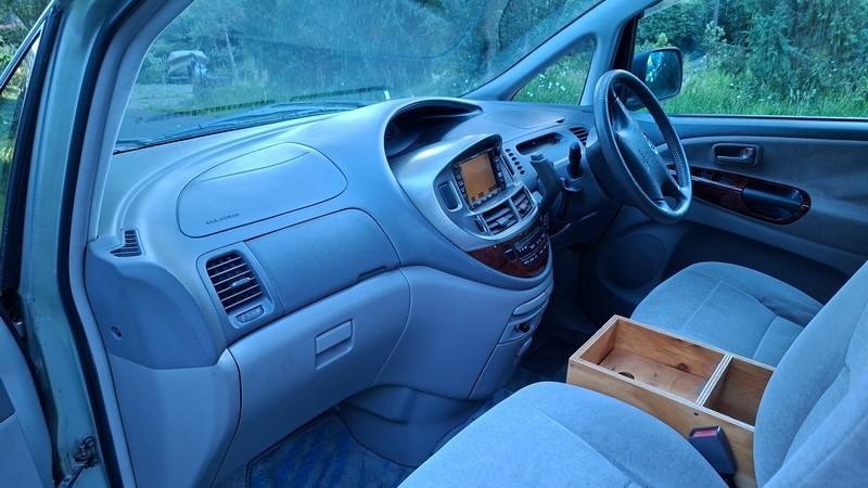 Dashboard and front seats of the ERT416 Toyota Estima, plywood console box between the seats