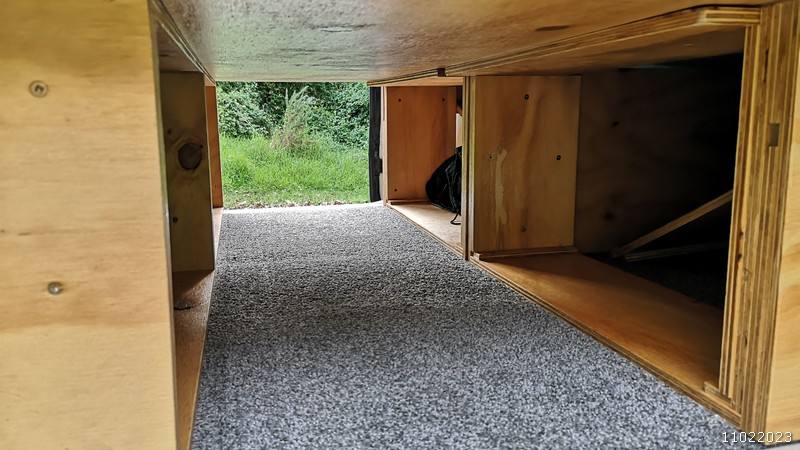 Storage space under the bed platform of the JBB773 campervan, seen through from the side door