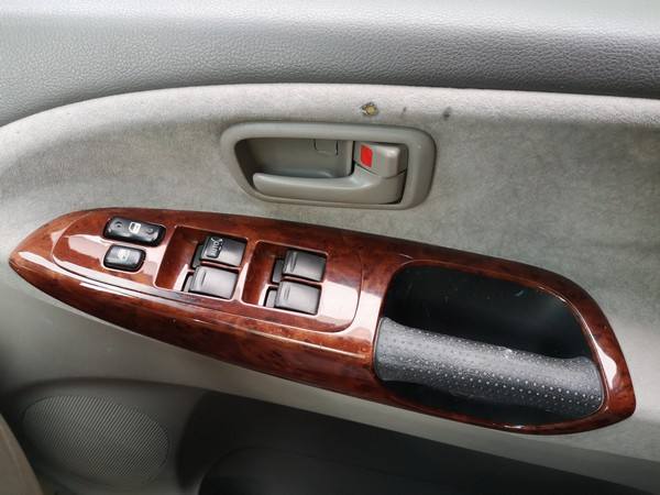 Driver's door armrest and window switches in the FPS382 Toyota Estima campervan