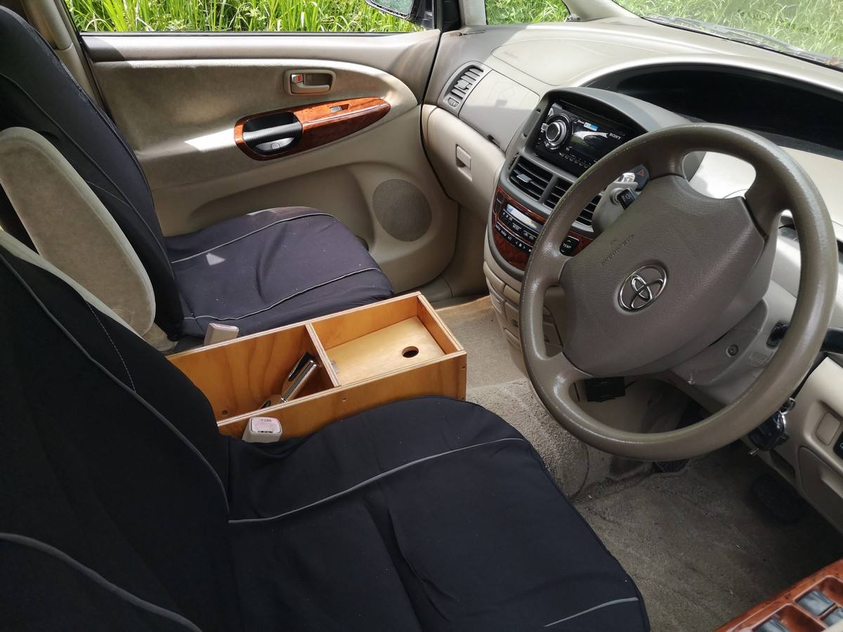 Front seats, steering wheel and plywood console box of the KBZ76 Toyota Estima campervan