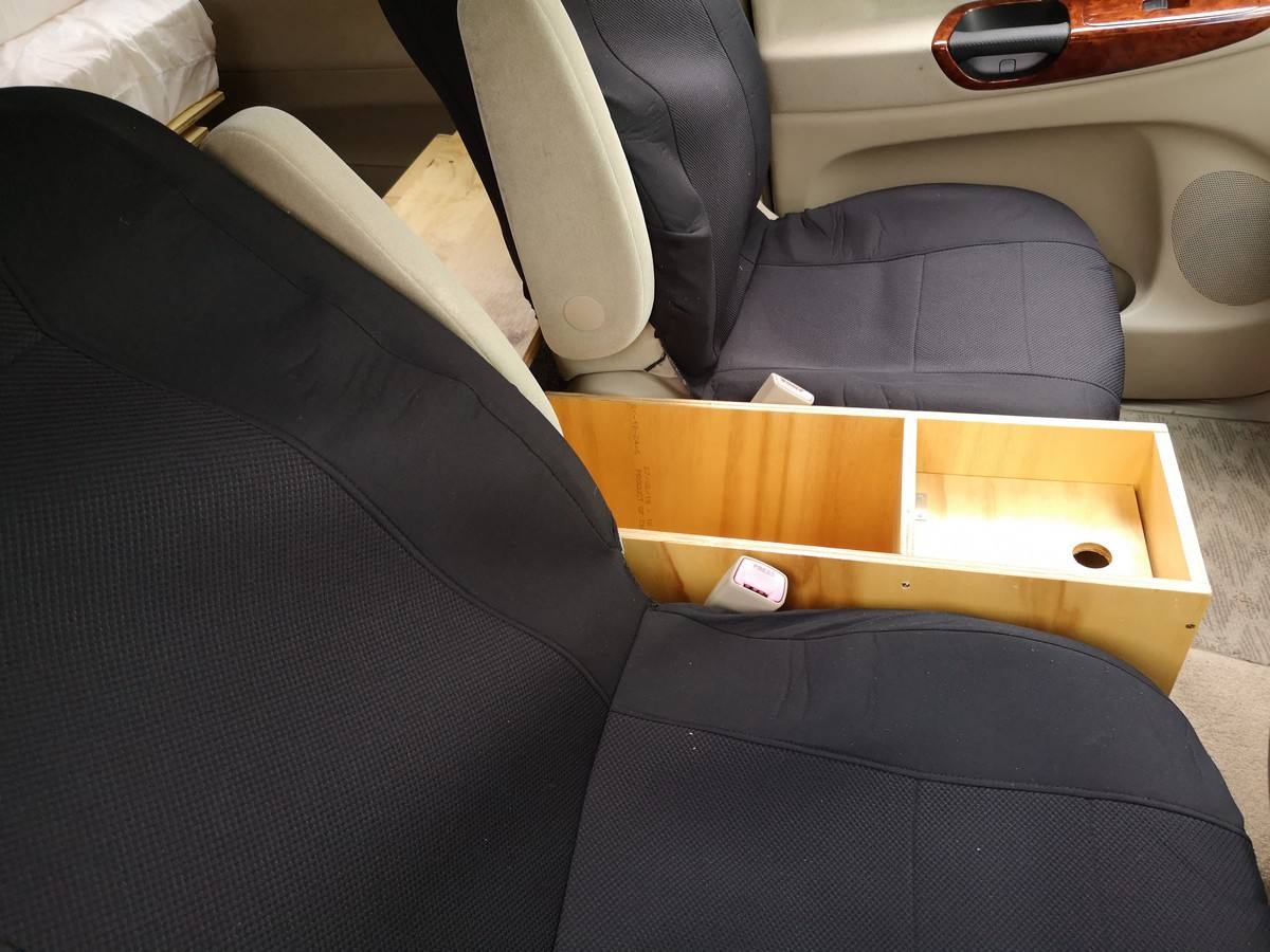 Plywood console box fitted between the front seats of the KZR927 Toyota Estima campervan