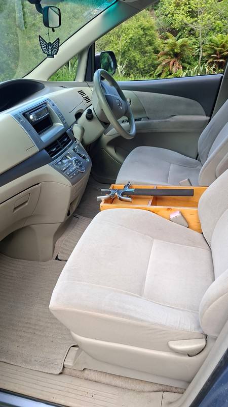 Front seats, steering wheel and timber console shelf of the EYC409 Toyota Estima campervan