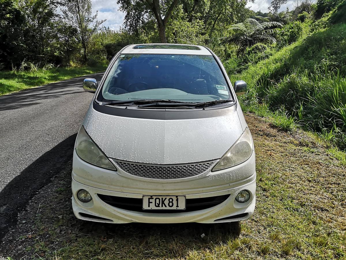 Front of the white Toyota Estima campervan with registration FQK81, sunroof visible in the roof