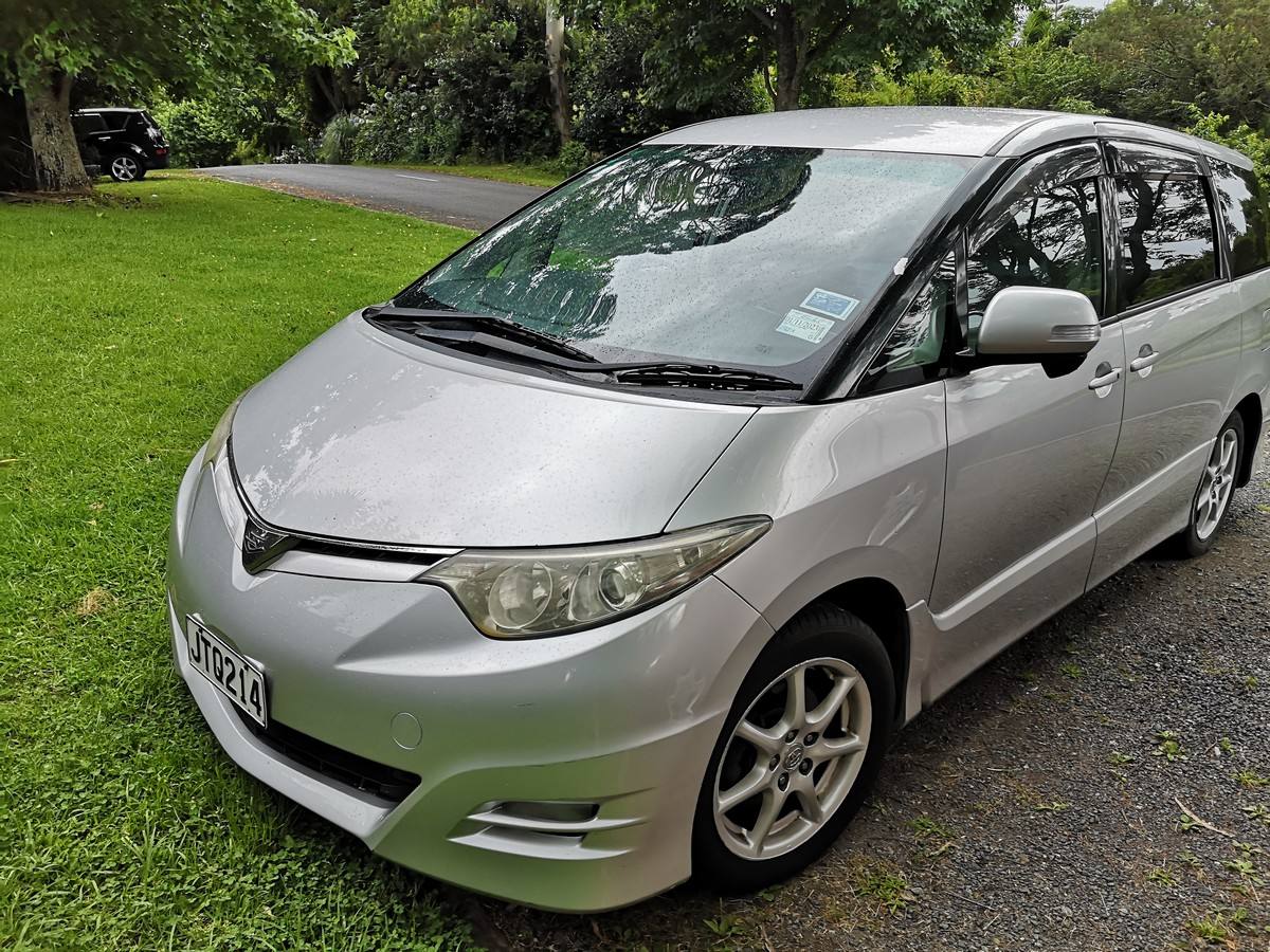 Silver 2007 Toyota Estima self-contained campervan for sale, registration JTQ214, parked on grass