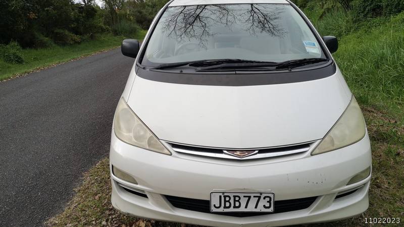 Front of the white Toyota Estima campervan with registration JBB773, parked on a country road