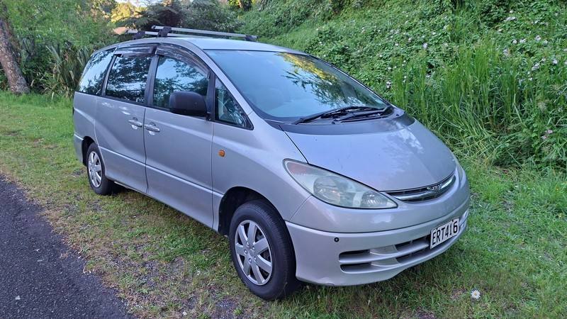 Front three-quarter view of the silver ERT416 Toyota Estima campervan with its roof rack