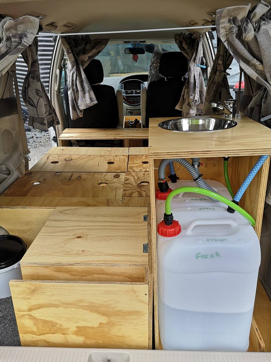 Inside the KZR927 campervan, plywood kitchen unit with stainless sink and the fresh water container plumbed in