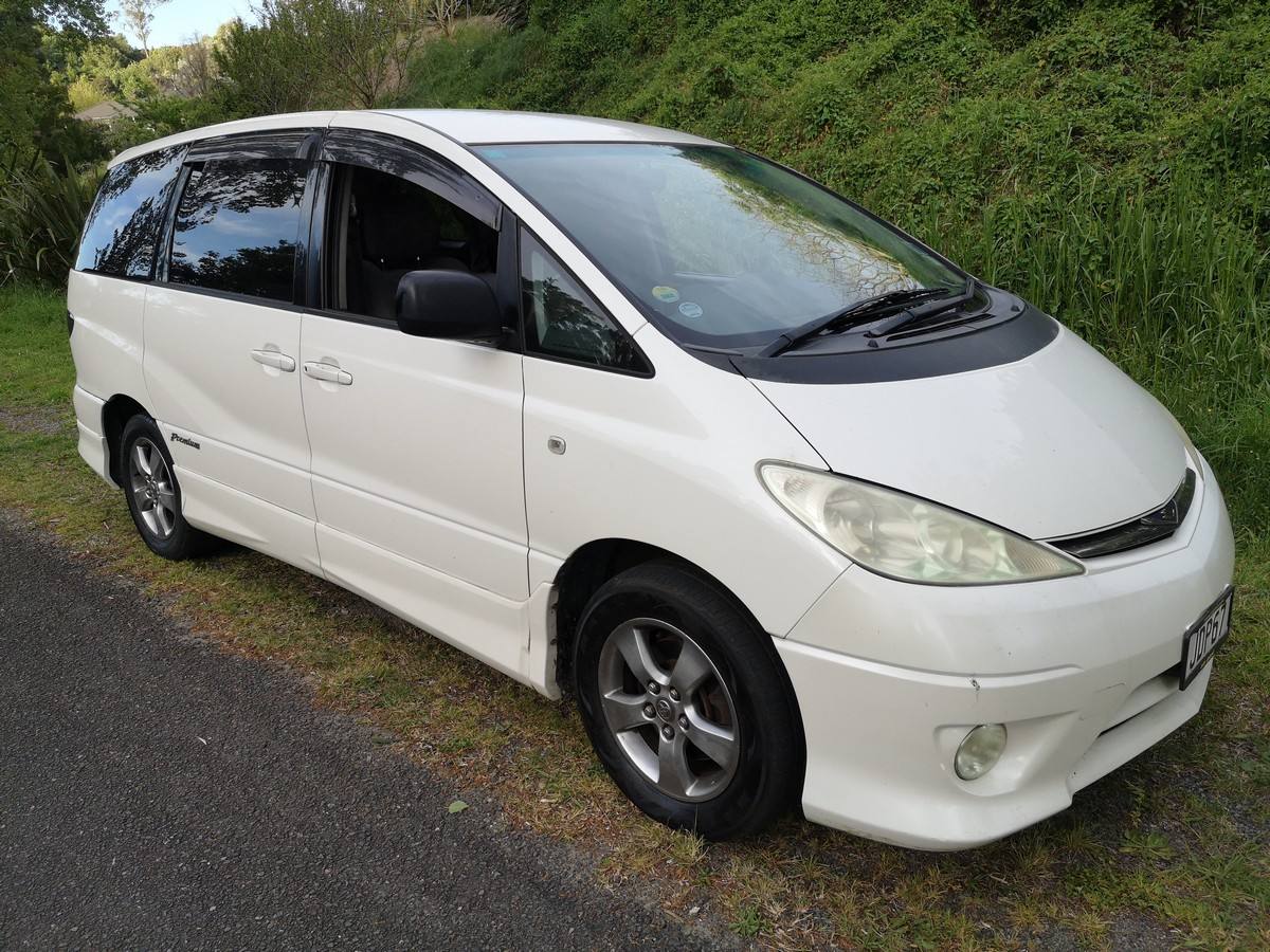 White 2005 Toyota Estima self-contained campervan for sale, front three-quarter view from the driver's side