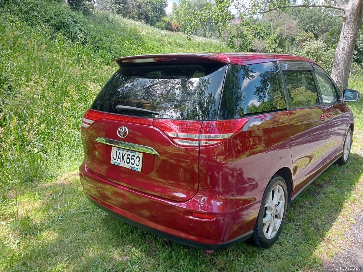 Rear three-quarter view of the JAK653 Toyota Estima campervan from the passenger side
