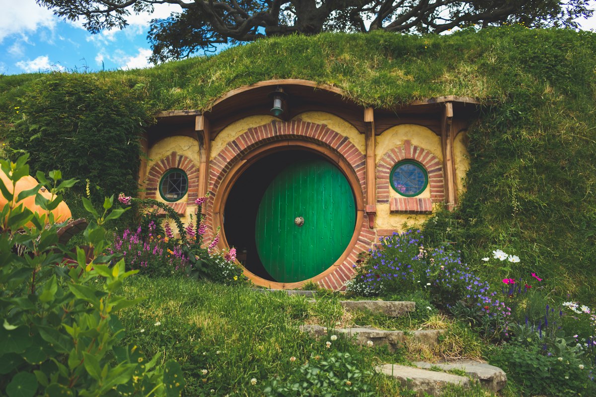 Hobbit hole with a green door at the Hobbiton Movie Set
