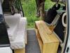 Bed made up on one side of the KZR927 campervan with the timber bench opposite