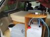 Kitchen unit in the GRH325 campervan with stainless sink, portable toilet and fresh water container below