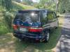 Rear three-quarter view of the dark blue 2000 Toyota Estima campervan FDK492