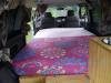 Inside the JDP67 campervan looking forward over the made-up bed to the front seats