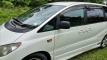 Driver's side of the white FJD528 Toyota Estima campervan, front doors and windows