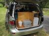 Tailgate open on the KBZ76 campervan, showing the kitchen unit, portable toilet and fresh water container