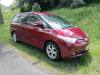 Red 2006 Toyota Estima self-contained campervan for sale, front three-quarter view from the driver's side