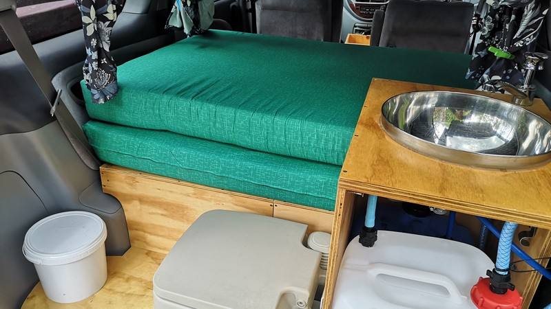 Kitchen unit in the FDK492 campervan with stainless sink, portable toilet and water container below