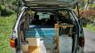 Tailgate open on the FBE338 campervan, showing the kitchen unit with sink, portable toilet and water container