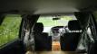 Inside the FJD528 campervan looking forward to the cab, curtains tied back at each window