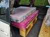 Side door open on the JDP67 campervan, mattresses stacked on the bed base with storage underneath