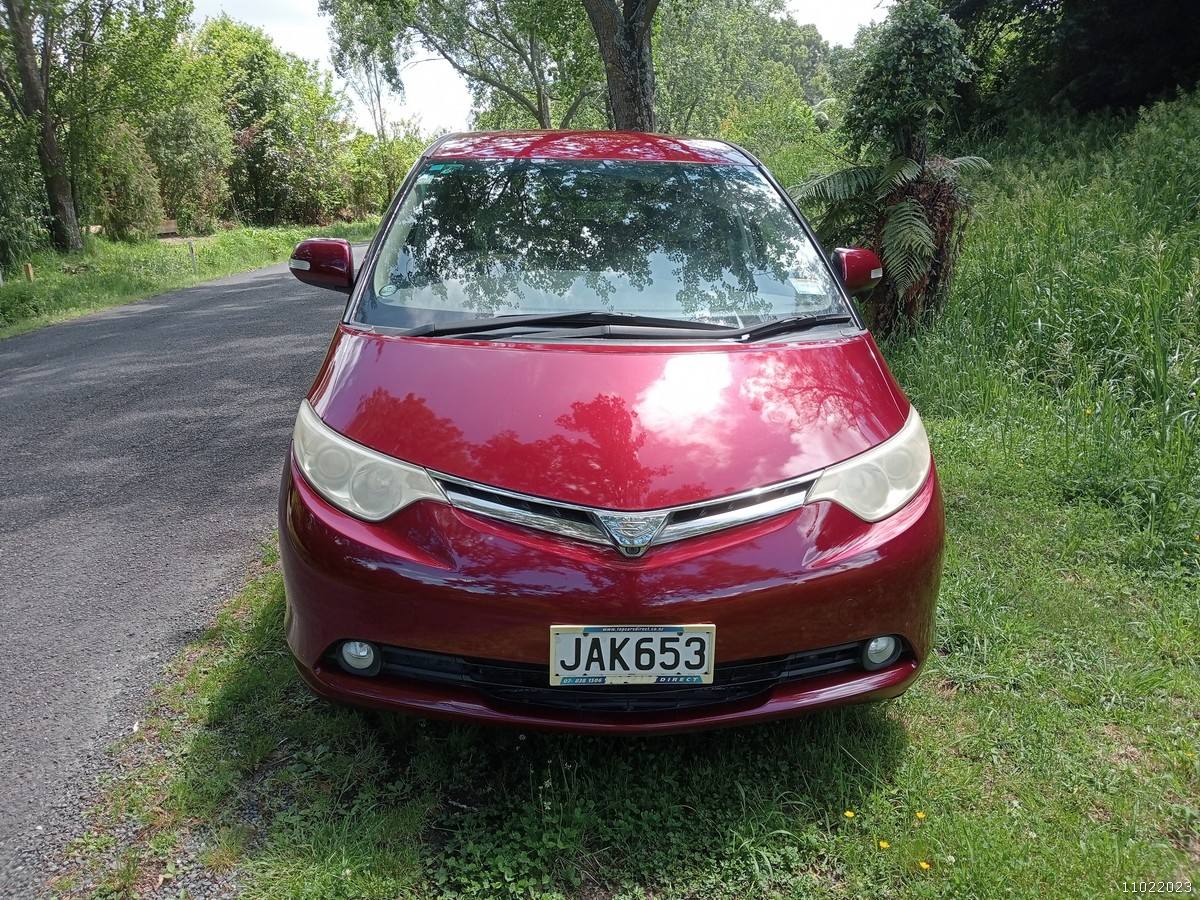 Front of the red Toyota Estima campervan with registration JAK653