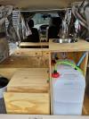 Inside the KZR927 campervan, plywood kitchen unit with stainless sink and the fresh water container plumbed in