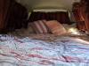 The JAK653 campervan's double bed made up with a duvet and pillows