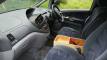 Dashboard and front seats of the FJD528 Toyota Estima, with the plywood console box between them
