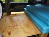 Plywood bed base panels in the JTQ214 campervan with the mattress stacked to one side