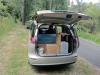 Tailgate open on the KHP570 campervan, showing the bed, kitchen unit and water container
