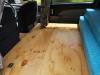 Plywood bed base of the JTQ214 campervan laid out flat, mattress folded to one side