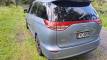 Rear three-quarter view of the blue 2007 Toyota Estima campervan EYC409 parked on grass