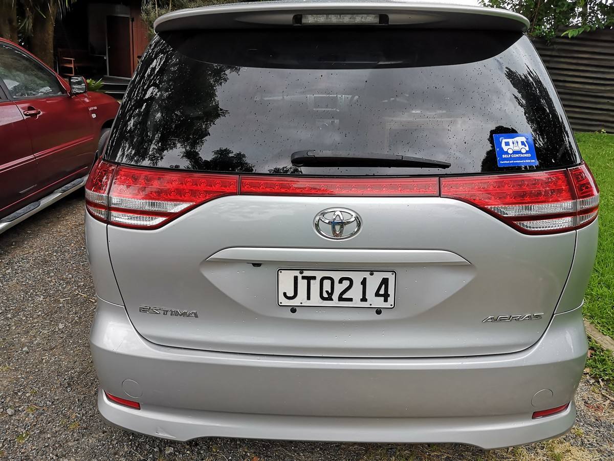 Back of the silver Toyota Estima campervan with registration JTQ214