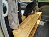Timber bench and table built between the seats of the JTQ214 campervan, curtains drawn back