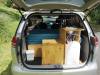 Tailgate open on the JTQ214 campervan, showing the kitchen unit, water container, portable toilet and bed