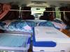 Inside the JAK653 campervan set up for travelling, bed made up with the chilly bin and storage boxes