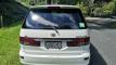 Back of the white Toyota Estima campervan with registration GQG541 and the green self-contained sticker