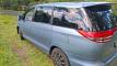 Side and rear of the blue EYC409 Toyota Estima campervan on a country road